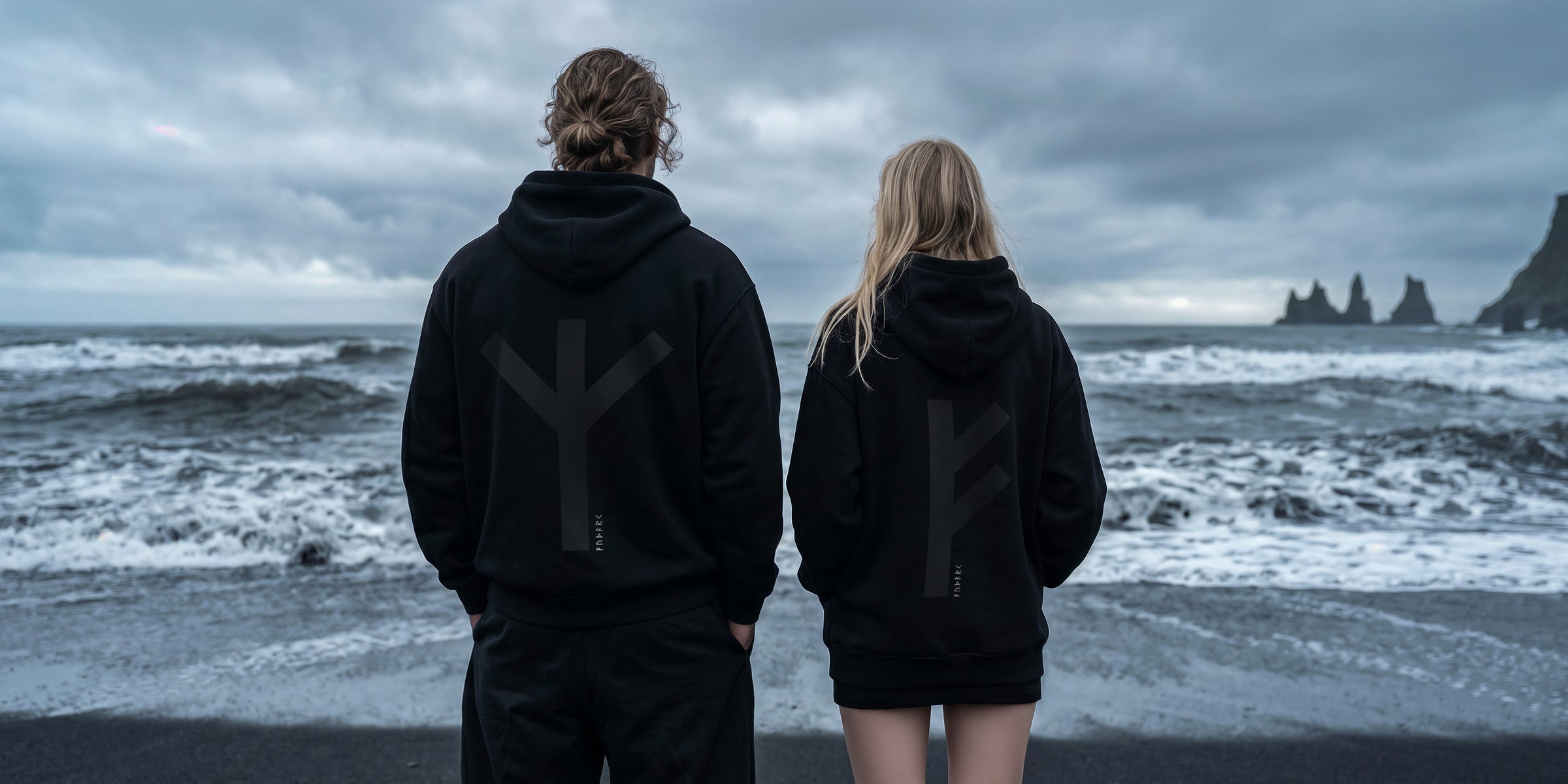 Black minimalist hoodie featuring a large Thurisaz rune printed on the back, symbolizing protection and raw force. Clean silhouette with relaxed fit, matte fabric texture, and subtle streetwear aesthetic, photographed from a partial rear angle with soft, moody lighting.