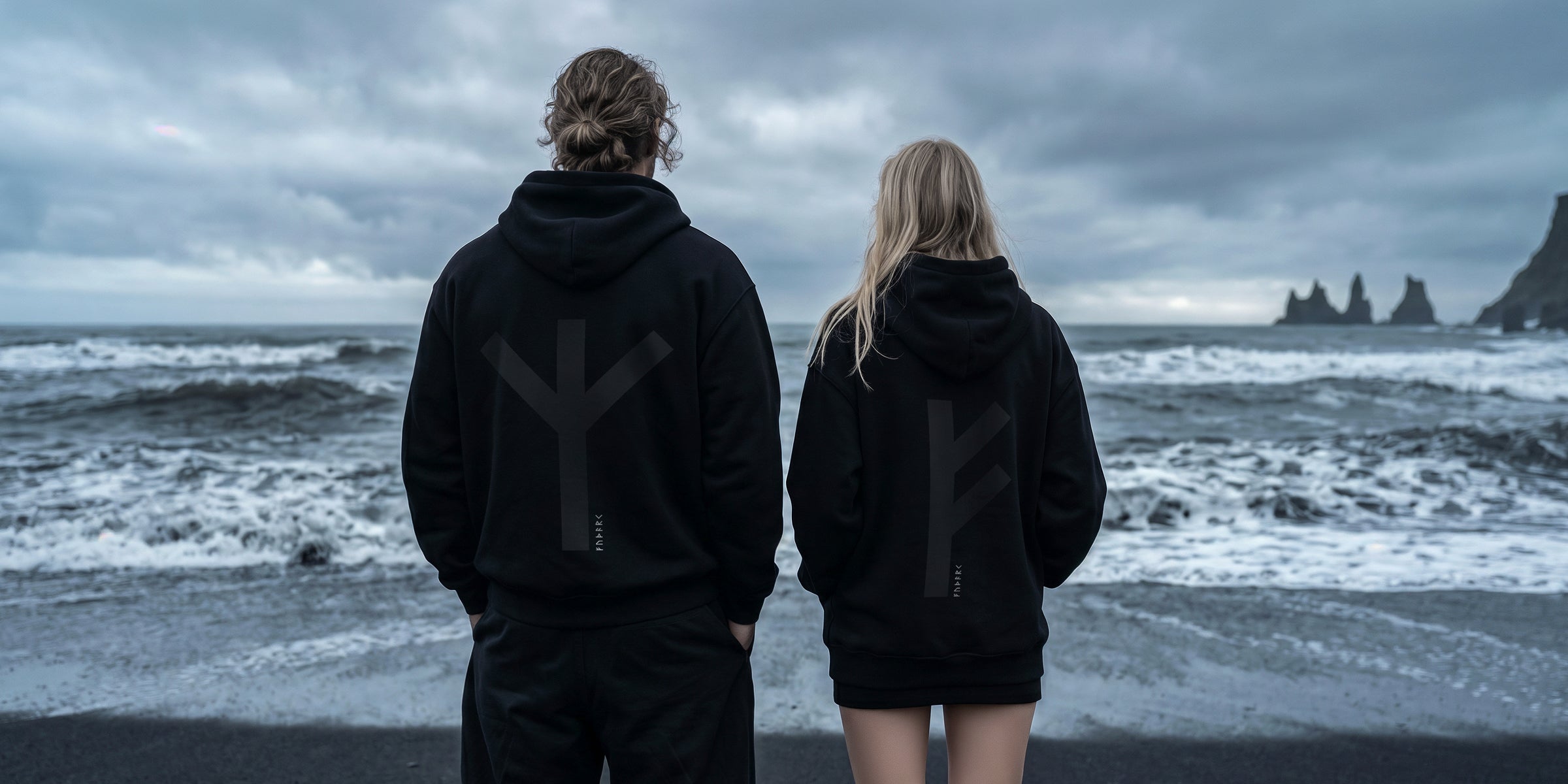 Black minimalist hoodie featuring a large Thurisaz rune printed on the back, symbolizing protection and raw force. Clean silhouette with relaxed fit, matte fabric texture, and subtle streetwear aesthetic, photographed from a partial rear angle with soft, moody lighting.