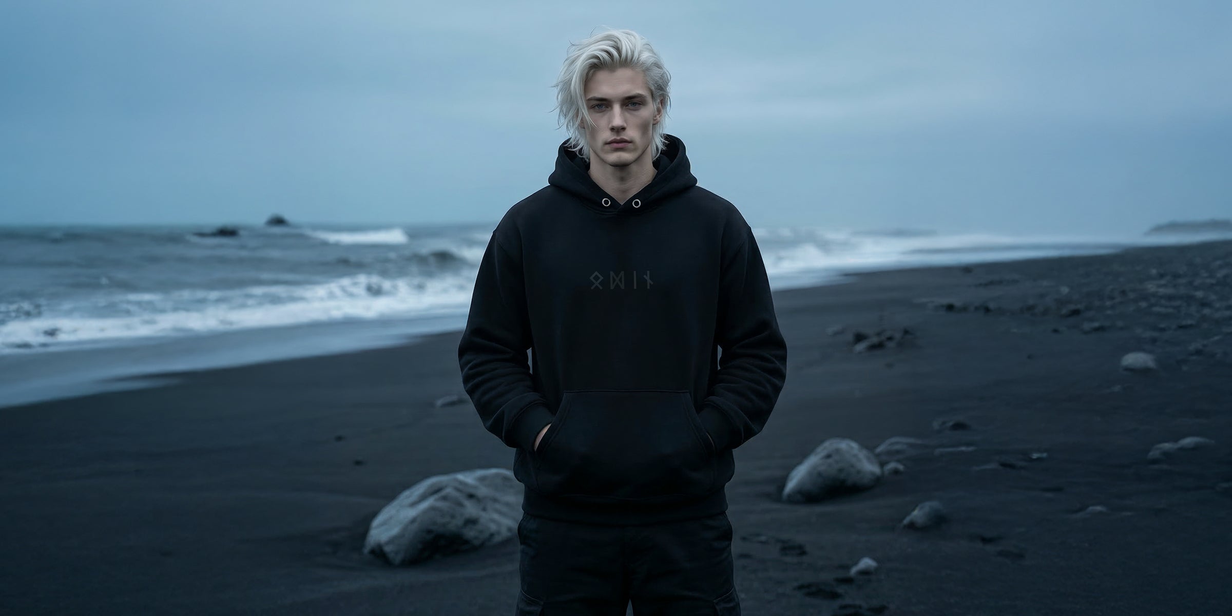 Black minimalist Odin hoodie featuring the name “Odin” spelled in Elder Futhark runes. Sleek Norse-inspired design, pullover style with adjustable hood and kangaroo pocket, subtle mythological vibe.
